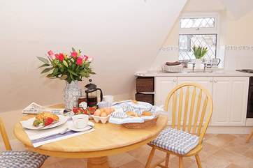 The kitchen/dining-room is bright and cheerful.