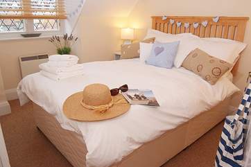 The bedroom is a lovely welcoming room.