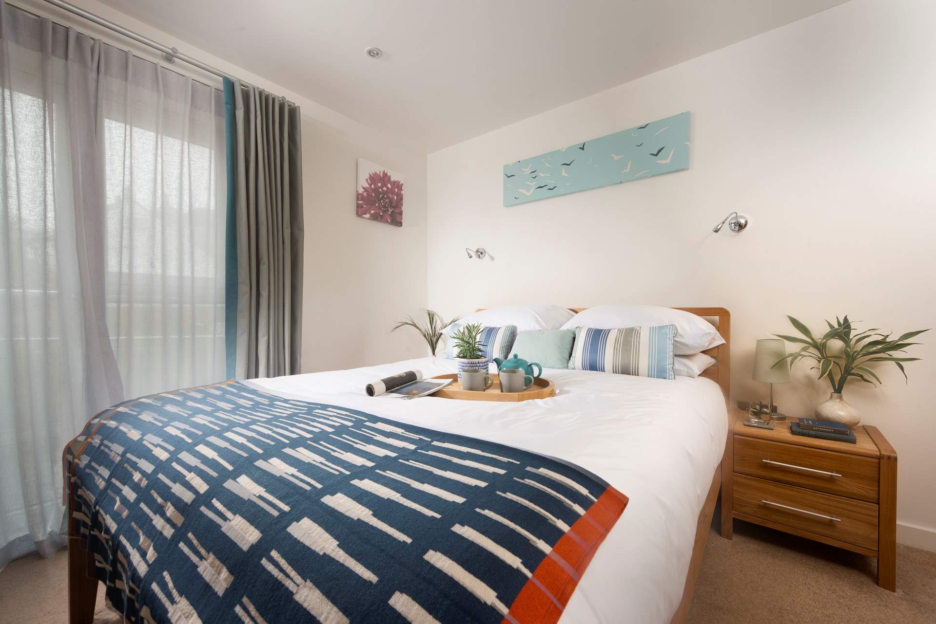 A stylish principal bedroom with comfy king-size bed.