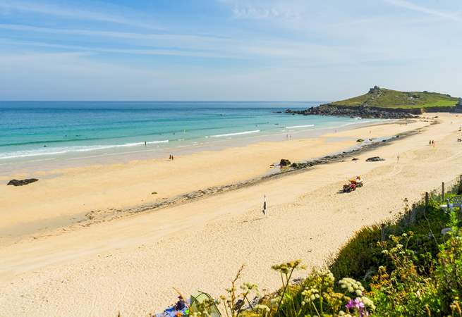 The golden sands and shimmering waters in neighbouring St Ives.