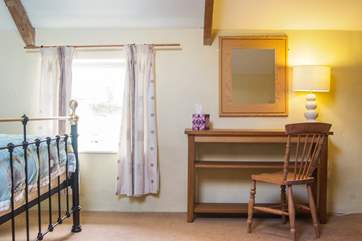 Three windows let plenty of light into the bedroom.
