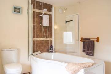 The bath with fitted shower can be accessed from both sides.