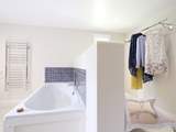 The en suite is partitioned from the dressing-area.