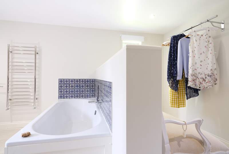 The en suite is partitioned from the dressing-area.