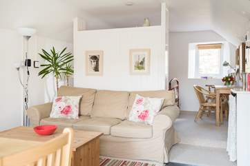 The sleeping-area is partially screened from the rest of the living-room.