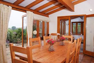 The dining-room links through to a further sun-room, both with French windows to the little garden.