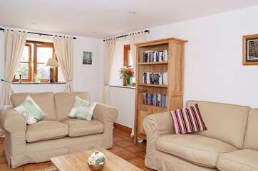 The light and airy sitting-room has a door through to the sun-room.