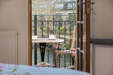 The master bedroom has a balcony looking out over the river.