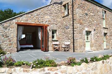 Folding glass doors open out from the double bedroom onto the front patio.