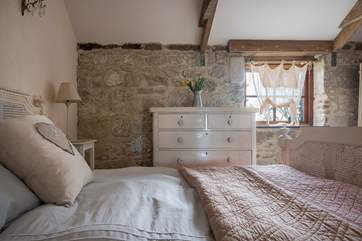 Beautiful linens and French styling in Bedroom 1.