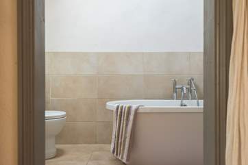 A free-standing bath in the en suite bathroom.