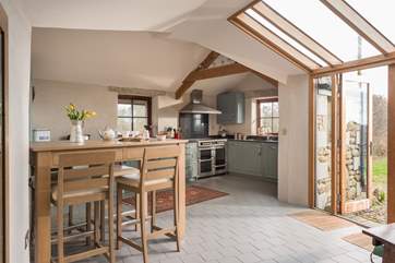 The light-filled open-plan living-room has kitchen, dining and sitting-areas.