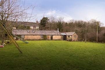 Looking back at the cottage from the edge of the big, level garden.