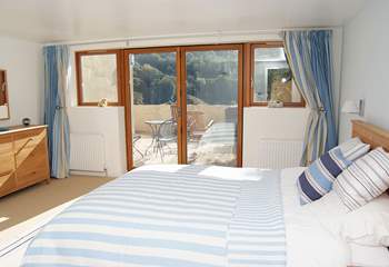 The gorgeous double bedroom also has glazed doors out to the patio.