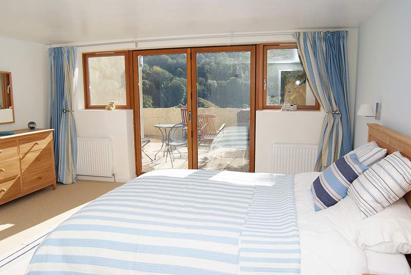 The gorgeous double bedroom also has glazed doors out to the patio.