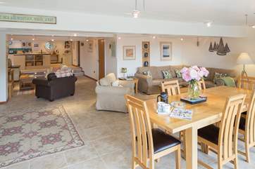 The sitting-room is remarkably spacious with the well-equipped kitchen at the far end.
