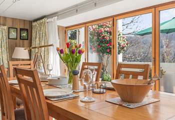 The patio is approached through floor to ceiling glass doors and windows.