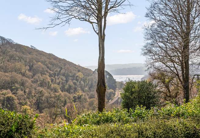 The view from the patio in front of the cottage, with the River Dart and Dartmouth in the distance and the steam railway running along the bottom of the valley.
