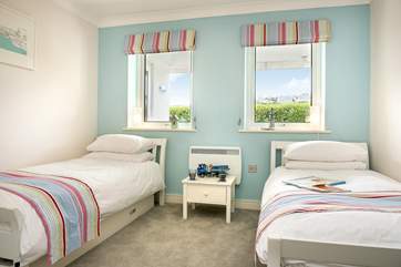 The twin bedroom has very bright and cheerful fabrics.