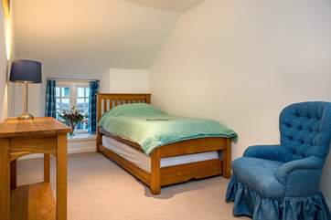 The single bedroom on the first floor is comfortably furnished.