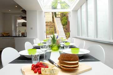 The glass-roofed dining-area leads out to the garden.