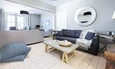 The sitting-room is divided into two seating areas, both equally as stylish - Thumbnail Image