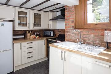 The well-equipped kitchen. The back door in the kitchen opens on to the steep stone steps leading up to the terraced garden.