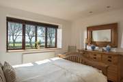 This lovely bedroom is furnished with solid wood furniture and fresh linens.