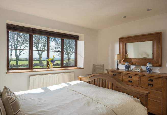 This lovely bedroom is furnished with solid wood furniture and fresh linens.