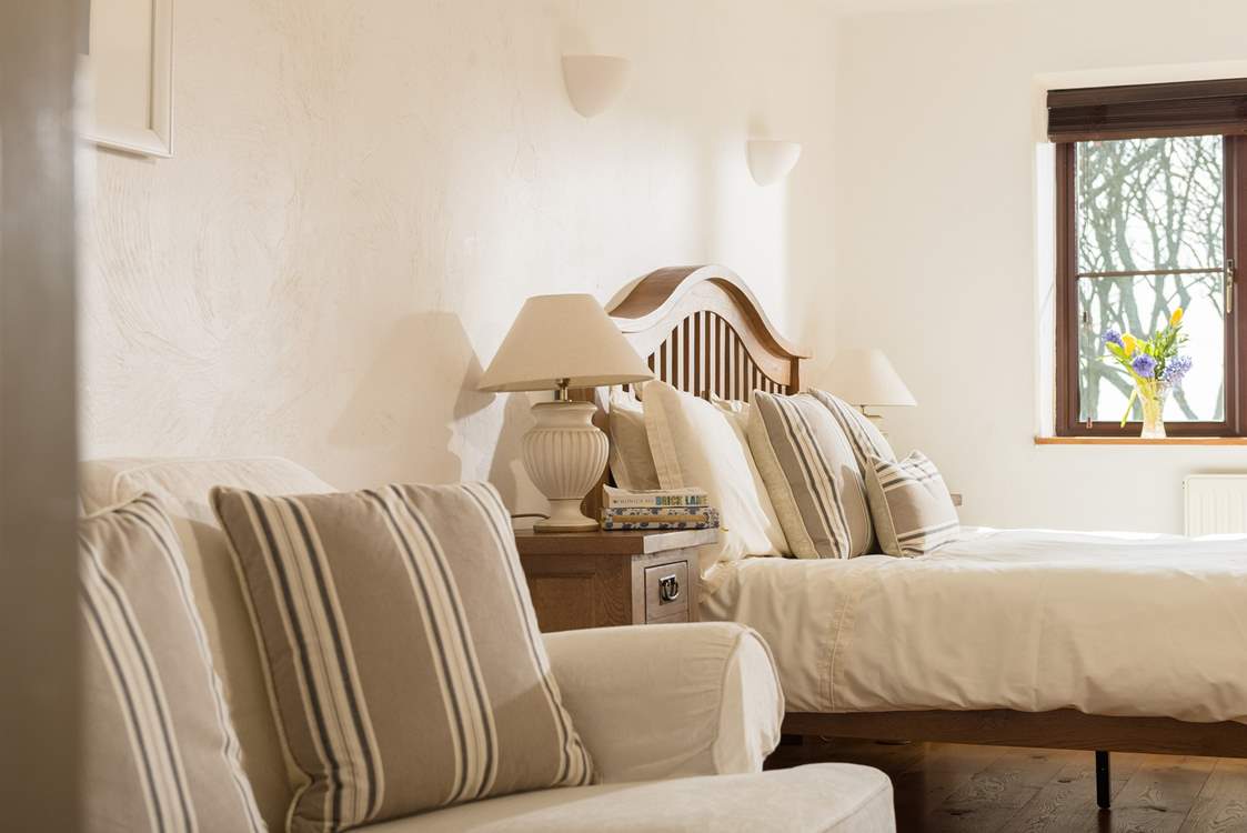 This bedroom also has a sofa for relaxing.