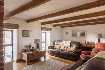 The sitting-room overlooks the garden to one side, and the courtyard on the other.
