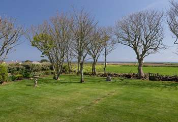 The view beyond the garden to the sea is uninterrupted, apart from the trees.