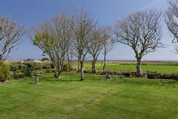 The view beyond the garden to the sea is uninterrupted, apart from the trees.