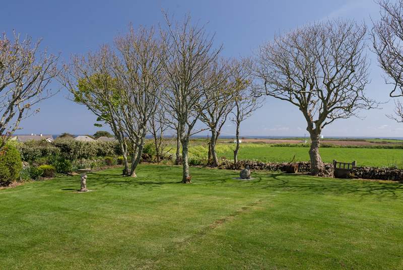 The view beyond the garden to the sea is uninterrupted, apart from the trees.