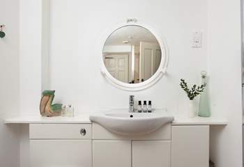 The light and airy shower-room has a port hole mirror.