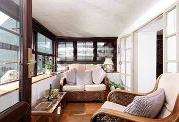The sun-room is the perfect spot to relax after exploring the nearby South West Coast Path.