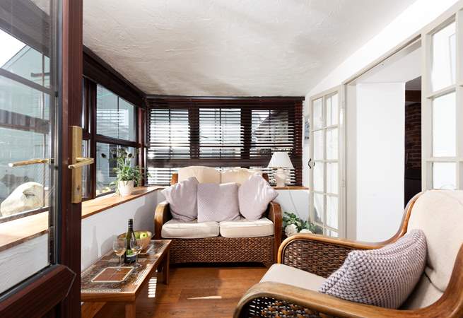 The sun-room is the perfect spot to relax after exploring the nearby South West Coast Path.