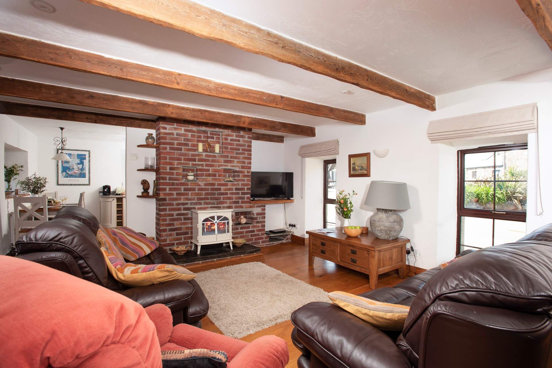 The traditional sitting-room features beautiful  beams.