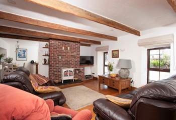 The traditional sitting-room features beautiful  beams.