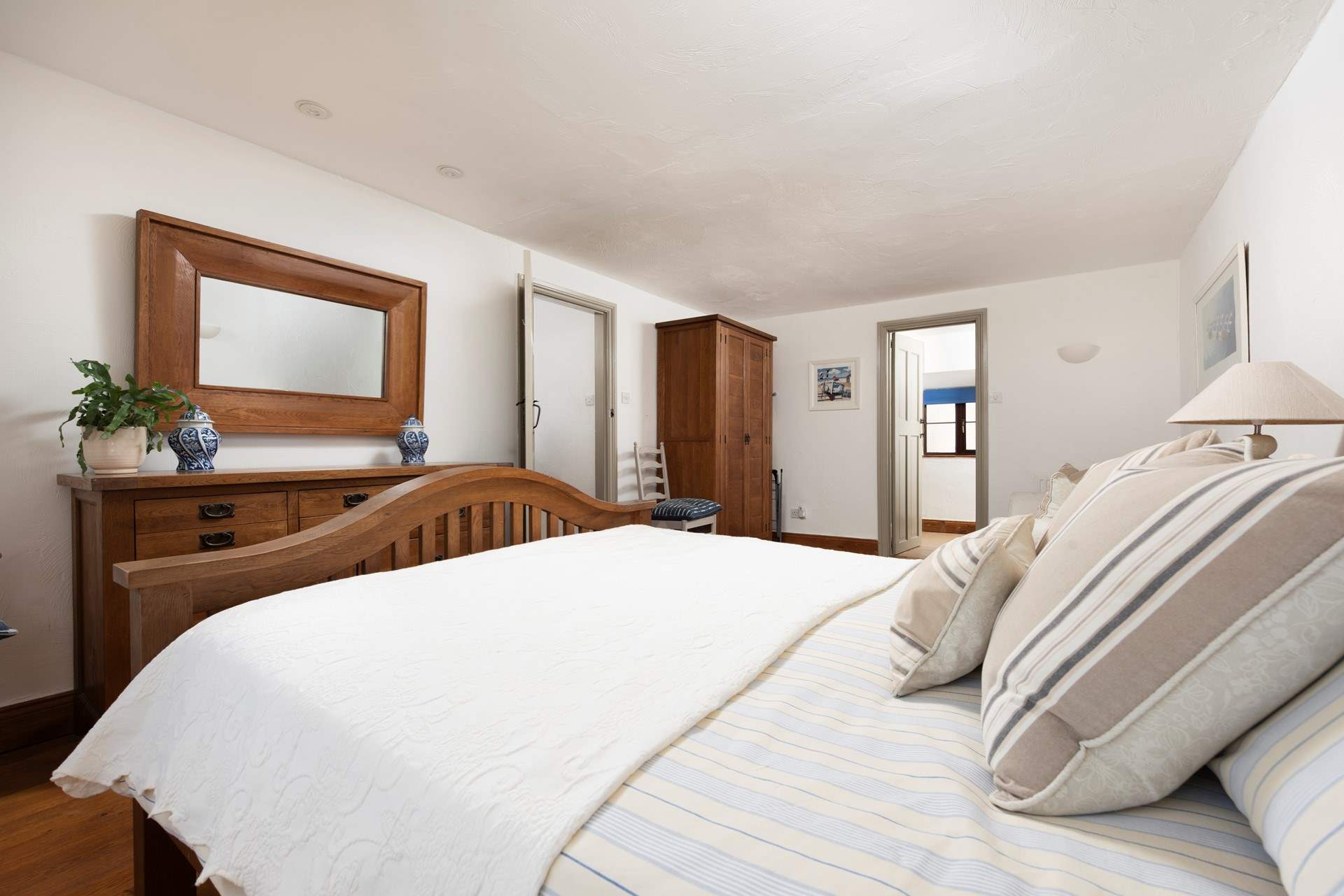 The spacious principal bedroom is designed with a relaxing neutral palette.