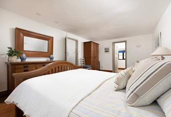 The spacious principal bedroom is designed with a relaxing neutral palette.