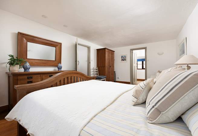 The spacious principal bedroom is designed with a relaxing neutral palette.