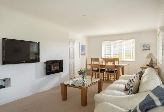 A wall mounted electric fire adds a cosy glow on a cool evening.