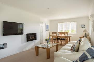 A wall mounted electric fire adds a cosy glow on a cool evening.
