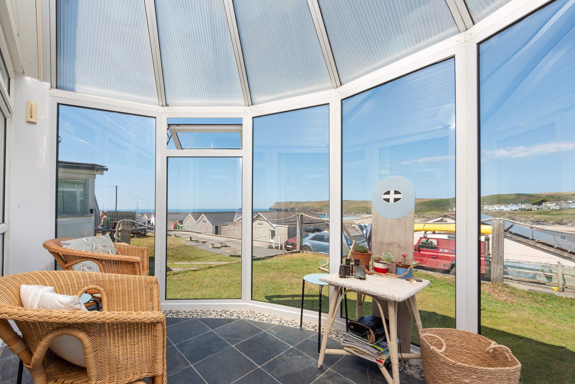 Chill out in the conservatory, enjoying the view down to the beach.