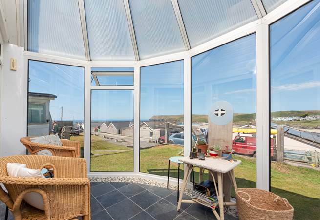 Chill out in the conservatory, enjoying the view down to the beach.