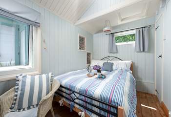 A comfy double bed awaits in bedroom 2.