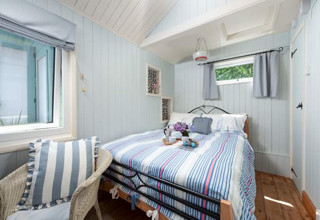 A comfy double bed awaits in bedroom 2.