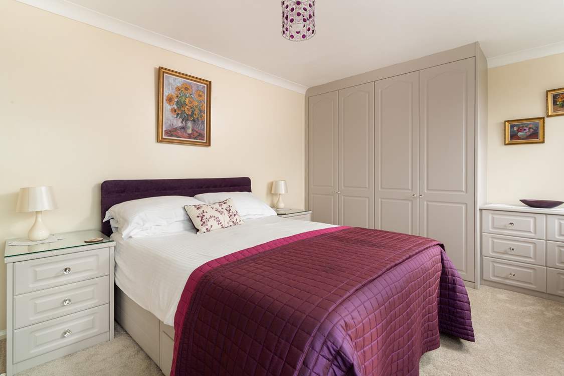 The comfortable, primary bedroom with plenty of storage.