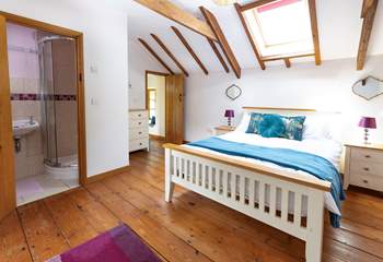 The delightful double bedroom is light and bright thanks to the Velux window.